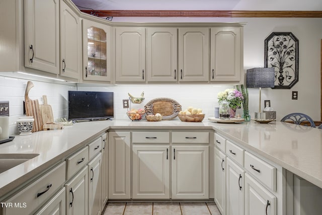 768 Lake Point Dr, Piney Flats, TN 37686 - kitchen featuring light countertops, light tile patterned floors, glass insert cabinets, and tasteful backsplash