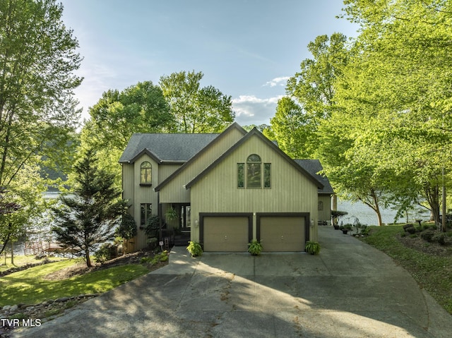 768 Lake Point Dr, Piney Flats, TN 37686 - view of front facade with an attached garage, a shingled roof, and driveway