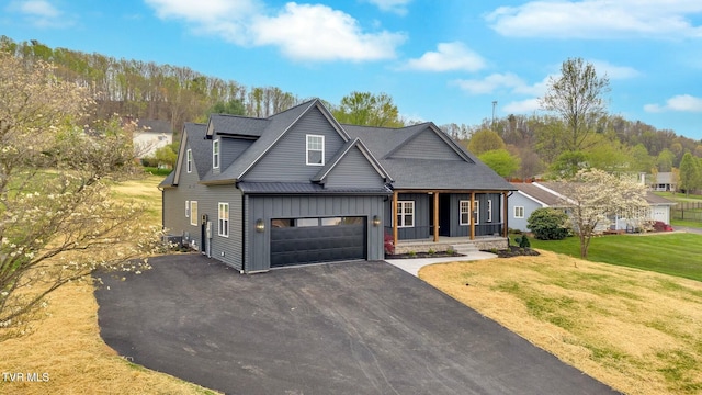 330 Bogey Dr, Abingdon, VA 24211 - view of front of house with aphalt driveway, board and batten siding, metal roof, covered porch, and a front yard