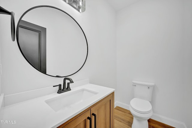 330 Bogey Dr, Abingdon, VA 24211 - half bathroom with baseboards, wood finished floors, vanity, and toilet