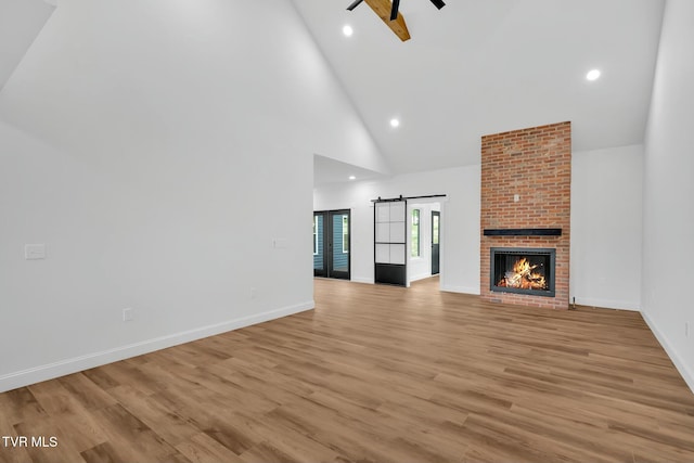 330 Bogey Dr, Abingdon, VA 24211 - unfurnished living room with baseboards, a ceiling fan, high vaulted ceiling, and light wood-style flooring