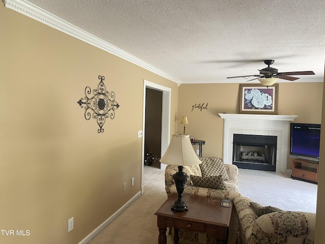 living area featuring a ceiling fan, ornamental molding, a textured ceiling, and light colored carpet