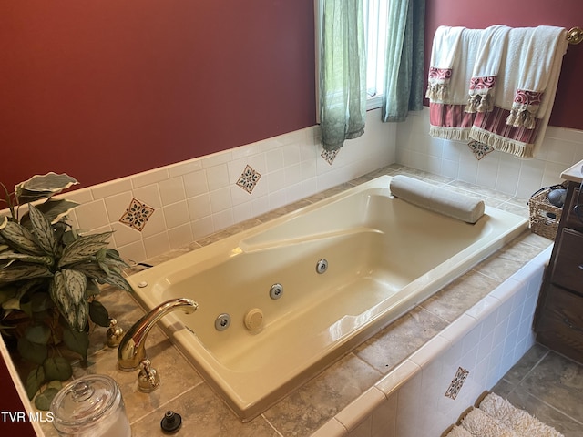 bathroom featuring tile patterned floors and a tub with jets