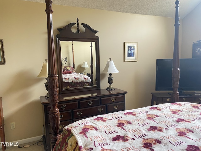 bedroom featuring carpet, a textured ceiling, and baseboards