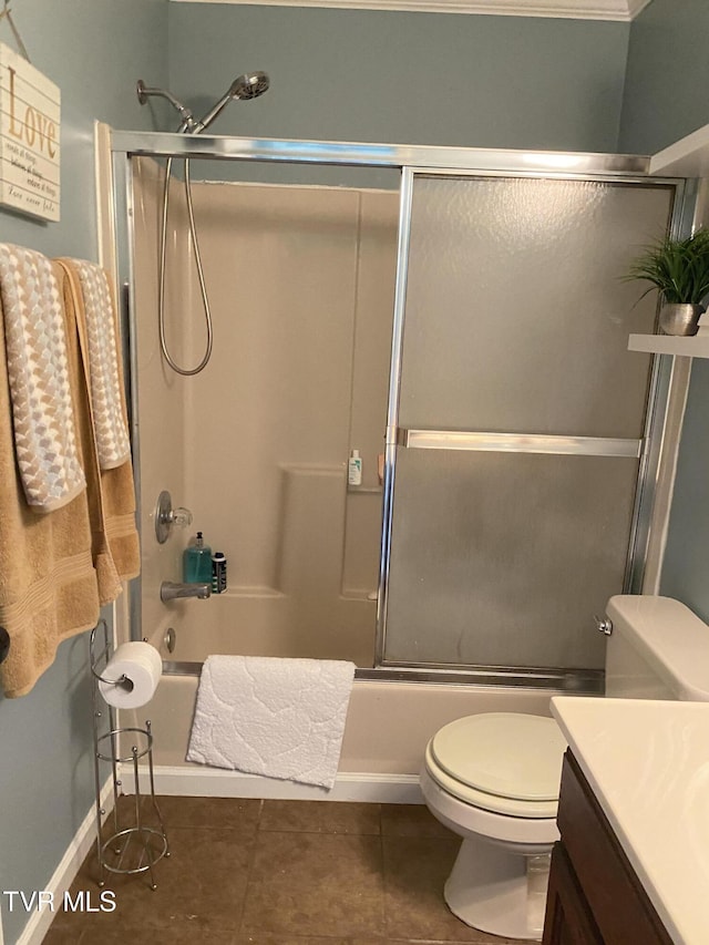 full bath featuring shower / bath combination with glass door, toilet, vanity, and tile patterned floors