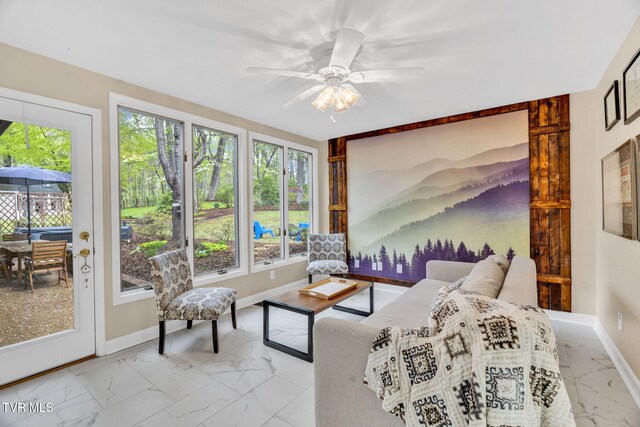interior space featuring baseboards, marble finish floor, and a wealth of natural light