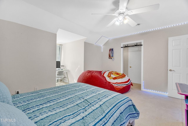 bedroom with vaulted ceiling, a ceiling fan, and carpet