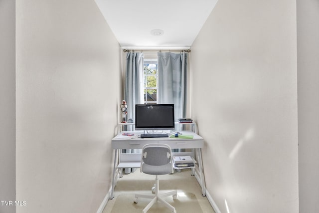 carpeted home office with baseboards