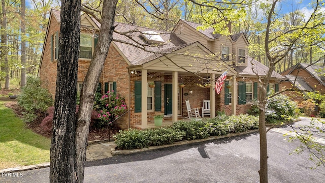 view of front of house with brick siding and a porch