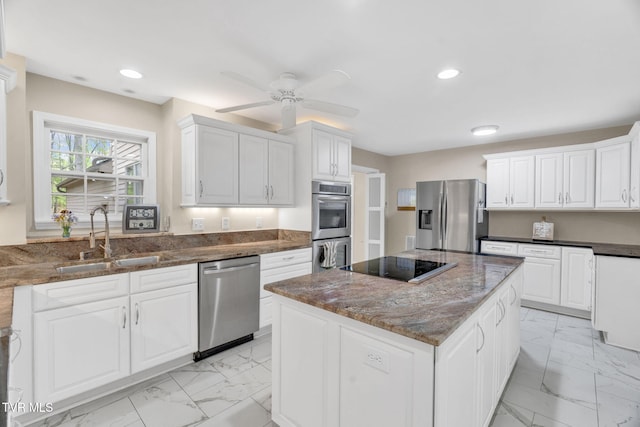 kitchen with marble finish floor, a sink, dark stone countertops, and appliances with stainless steel finishes
