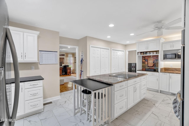 kitchen with a center island, marble finish floor, ceiling fan, stainless steel appliances, and recessed lighting