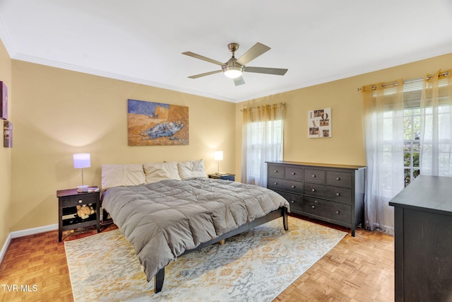 bedroom with baseboards, ceiling fan, and crown molding