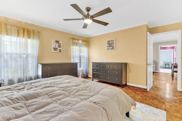 bedroom with ceiling fan, baseboards, ornamental molding, and multiple windows