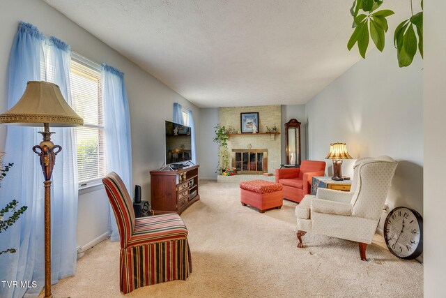 living area with a brick fireplace, carpet floors, a healthy amount of sunlight, and baseboards