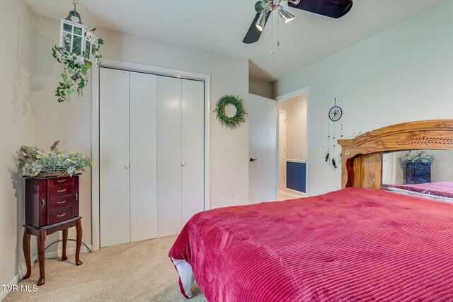 carpeted bedroom featuring a closet and a ceiling fan