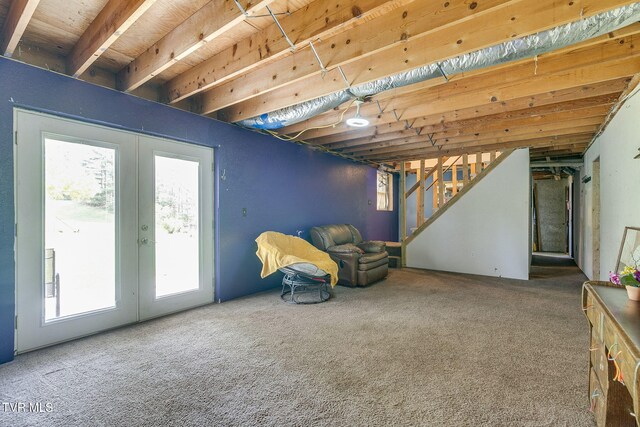 below grade area featuring a healthy amount of sunlight, carpet flooring, and french doors