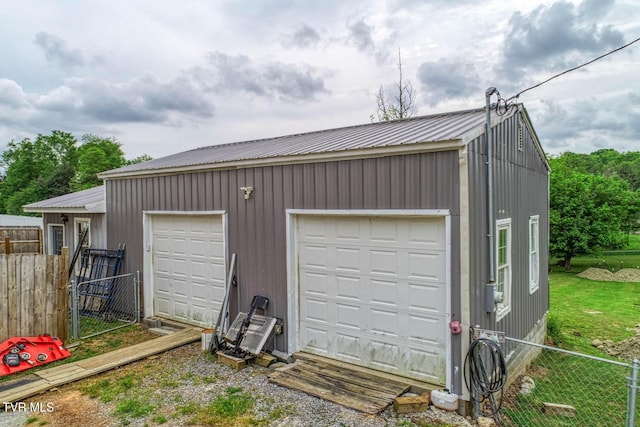 detached garage featuring fence