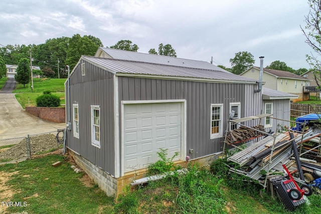detached garage featuring fence