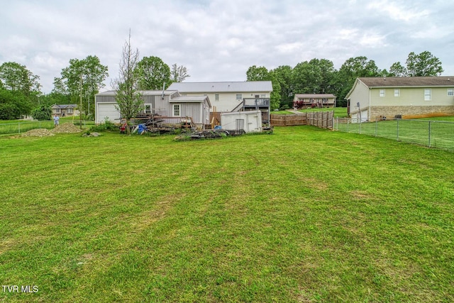 view of yard featuring an outdoor structure and fence