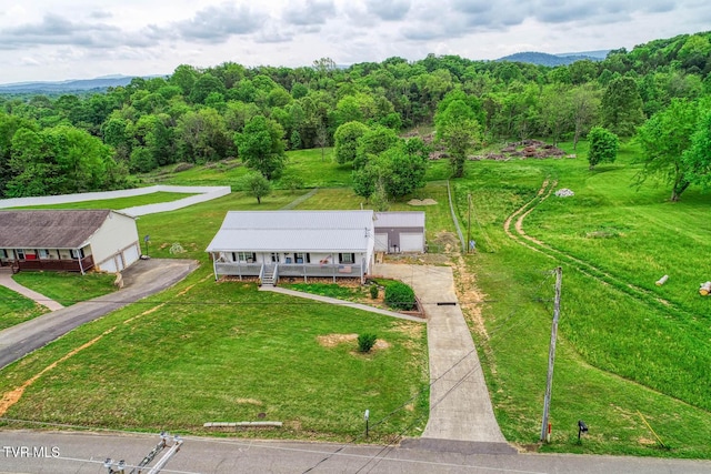 birds eye view of property featuring a wooded view