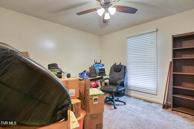office area featuring carpet floors, ceiling fan, baseboards, and visible vents