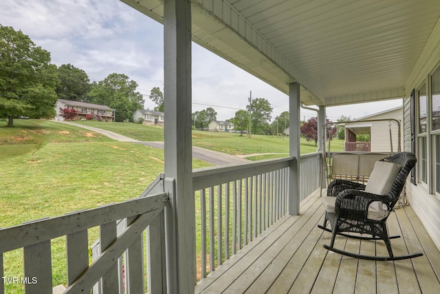 wooden terrace featuring a yard