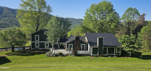 304 Tunnel Dr, Dryden, VA 24243 - view of front of home with a front lawn, a deck with mountain view, and a chimney