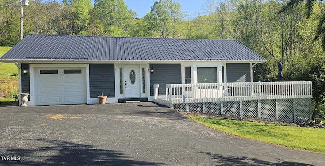 304 Tunnel Dr, Dryden, VA 24243 - view of front facade featuring driveway, metal roof, a porch, and a garage