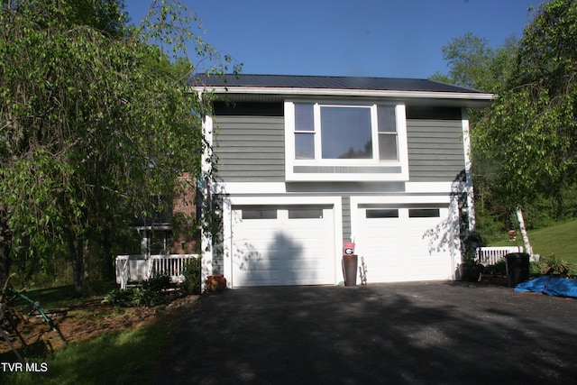 304 Tunnel Dr, Dryden, VA 24243 - view of property exterior with metal roof, aphalt driveway, and a garage