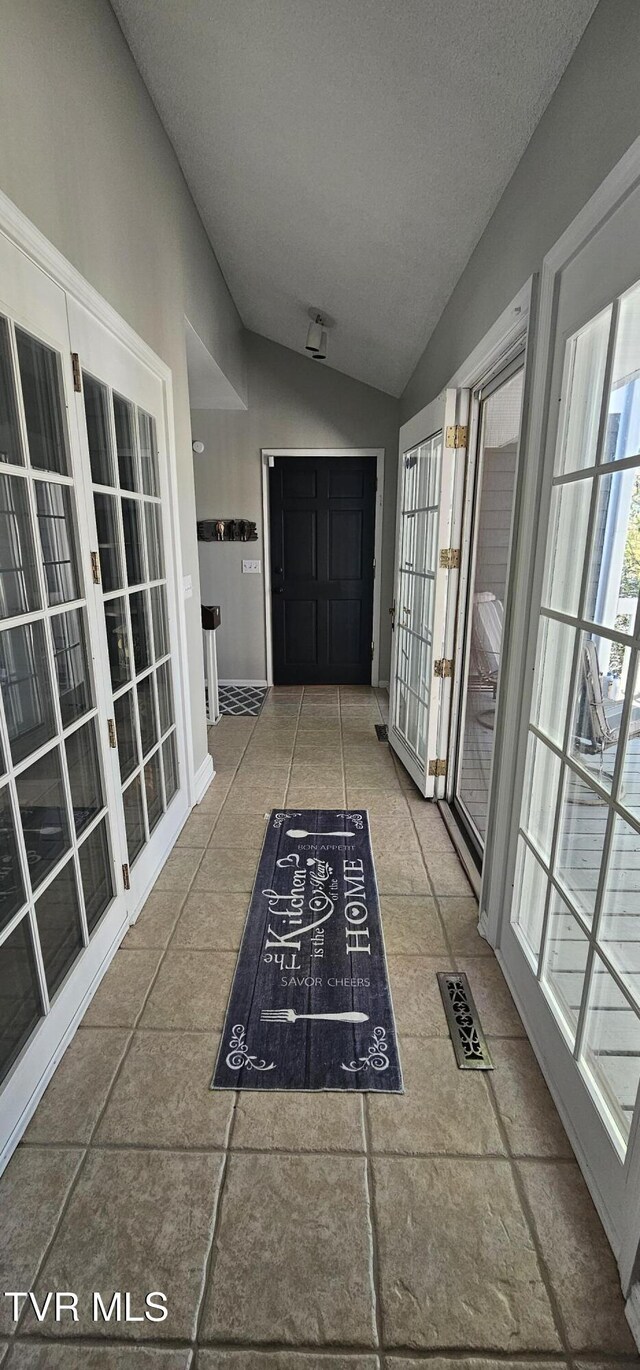 304 Tunnel Dr, Dryden, VA 24243 - hall with tile patterned floors, french doors, visible vents, and vaulted ceiling