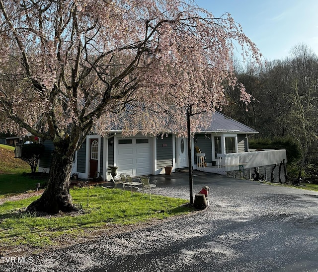 304 Tunnel Dr, Dryden, VA 24243 - view of front facade with driveway, metal roof, a porch, and an attached garage