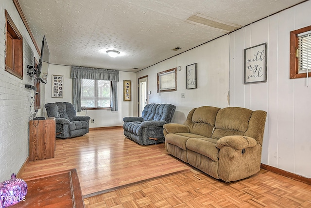 2856 Watauga Rd, Johnson City, TN 37601 - living area featuring parquet floors, baseboards, a textured ceiling, and visible vents