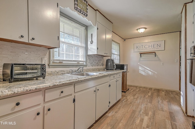 2856 Watauga Rd, Johnson City, TN 37601 - kitchen featuring a sink, white cabinets, a toaster, light countertops, and backsplash