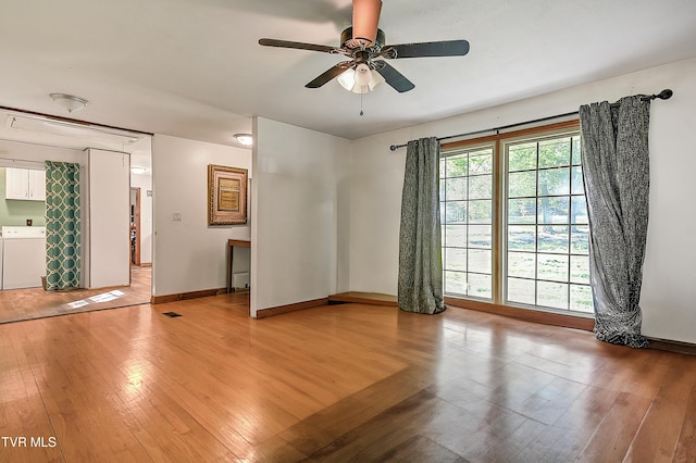 2856 Watauga Rd, Johnson City, TN 37601 - unfurnished room featuring light wood-style flooring, baseboards, washer and dryer, and ceiling fan