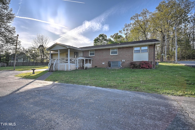 2856 Watauga Rd, Johnson City, TN 37601 - exterior space with brick siding, central air condition unit, a porch, and a front lawn