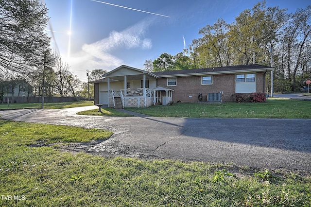 2856 Watauga Rd, Johnson City, TN 37601 - view of front of house with a front lawn, cooling unit, driveway, a porch, and brick siding