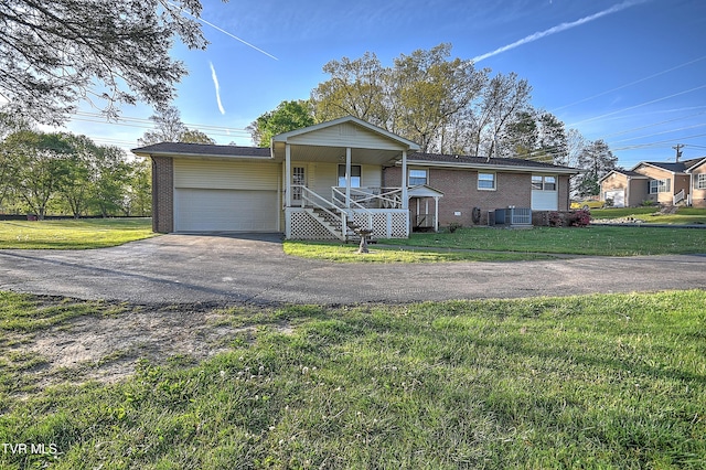 2856 Watauga Rd, Johnson City, TN 37601 - single story home featuring covered porch, brick siding, cooling unit, and a garage