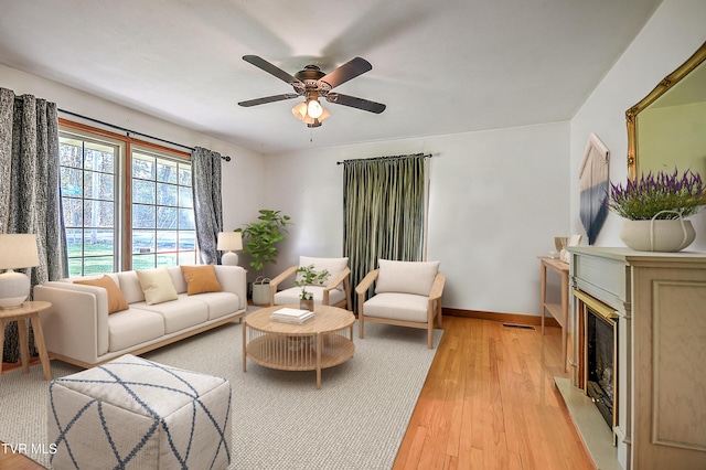 2856 Watauga Rd, Johnson City, TN 37601 - living area with light wood finished floors, visible vents, a ceiling fan, baseboards, and a fireplace
