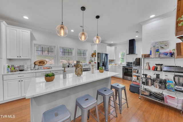 2040 Happy Valley Rd, Limestone, TN 37681 - kitchen with a breakfast bar area, appliances with stainless steel finishes, ventilation hood, white cabinets, and light wood finished floors