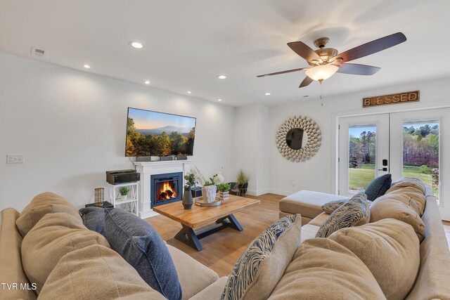 2040 Happy Valley Rd, Limestone, TN 37681 - living area with a warm lit fireplace, light wood finished floors, french doors, recessed lighting, and visible vents