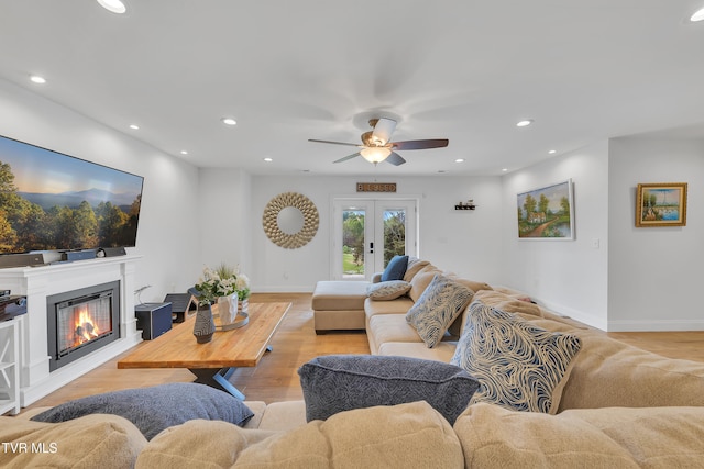 2040 Happy Valley Rd, Limestone, TN 37681 - living room featuring ceiling fan, a glass covered fireplace, french doors, light wood-style flooring, and baseboards