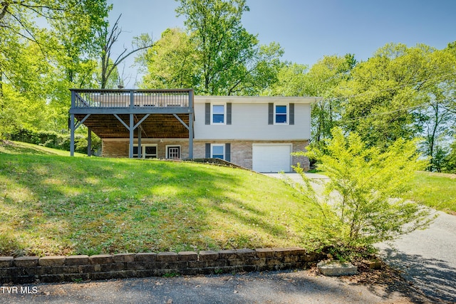 112 Fairwood St, Kingsport, TN 37660 - back of house featuring a garage, a lawn, driveway, and a deck
