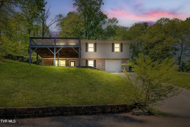 112 Fairwood St, Kingsport, TN 37660 - view of front of property featuring a garage, dirt driveway, a front yard, a wooden deck, and brick siding