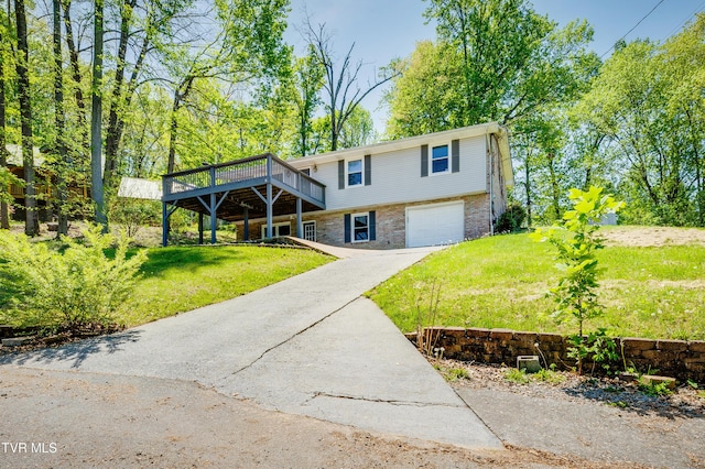 112 Fairwood St, Kingsport, TN 37660 - bi-level home with aphalt driveway, a front lawn, a wooden deck, brick siding, and a garage