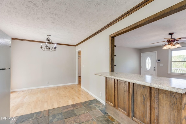112 Fairwood St, Kingsport, TN 37660 - kitchen with baseboards, freestanding refrigerator, ceiling fan with notable chandelier, wood finished floors, and light stone countertops