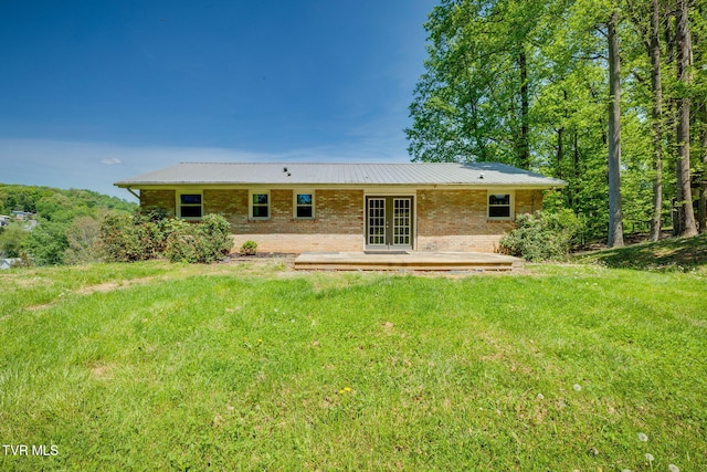 112 Fairwood St, Kingsport, TN 37660 - rear view of property with french doors, a yard, a patio, metal roof, and brick siding