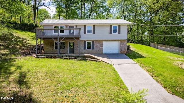 112 Fairwood St, Kingsport, TN 37660 - view of front facade with fence, concrete driveway, an attached garage, a front yard, and a deck