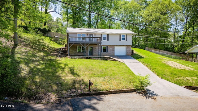 112 Fairwood St, Kingsport, TN 37660 - view of front of home with a garage, concrete driveway, fence, a front yard, and a wooden deck