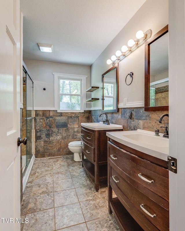 112 Fairwood St, Kingsport, TN 37660 - full bathroom with a wainscoted wall, a sink, tile walls, two vanities, and a stall shower