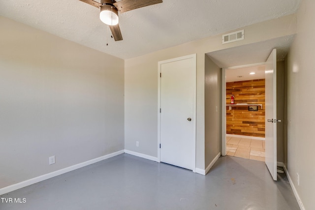 112 Fairwood St, Kingsport, TN 37660 - unfurnished bedroom with wood walls, visible vents, baseboards, a textured ceiling, and finished concrete flooring